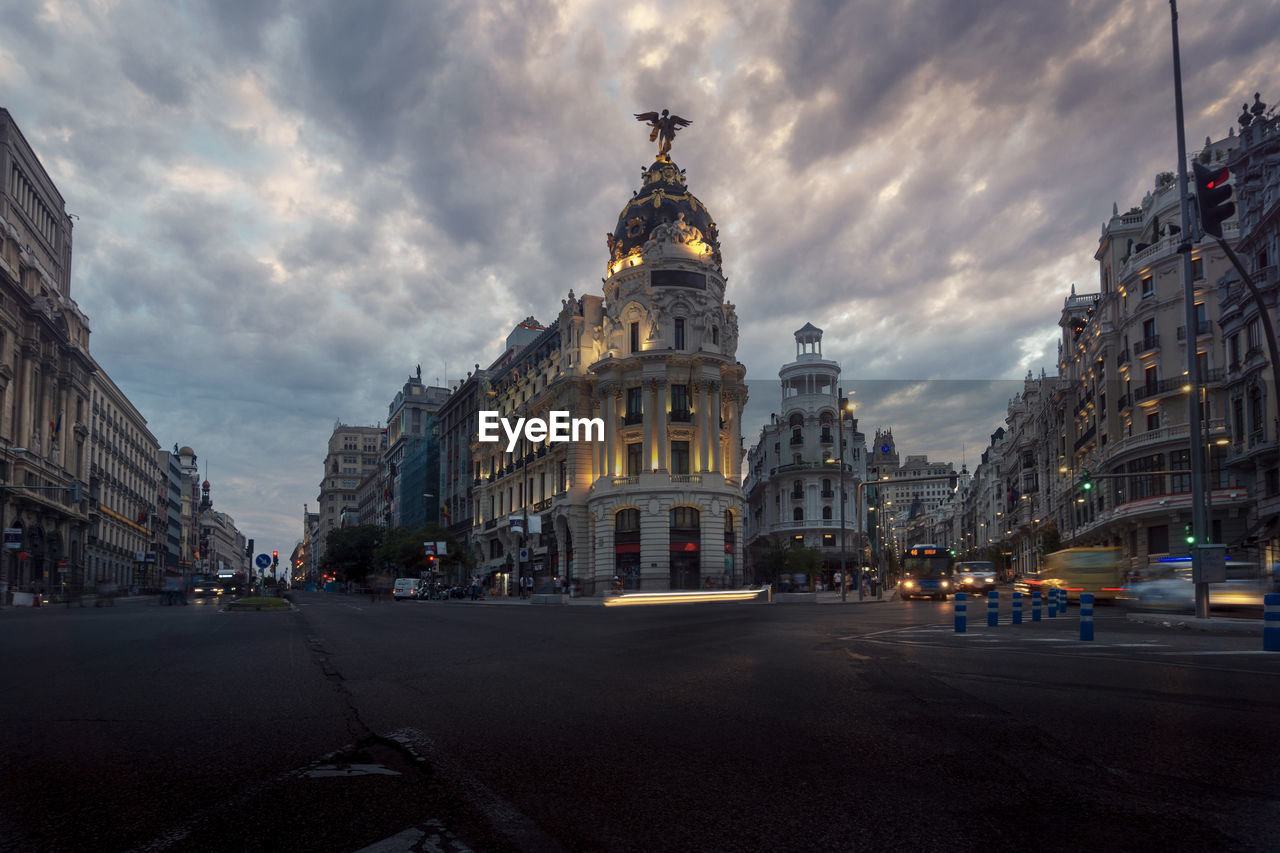 Low angle of famous metropolis building under cloudy sky in evening in madrid