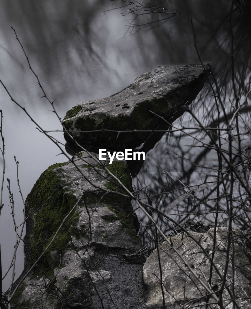 Close-up long exposure shot of a rocks above the surface of a lake