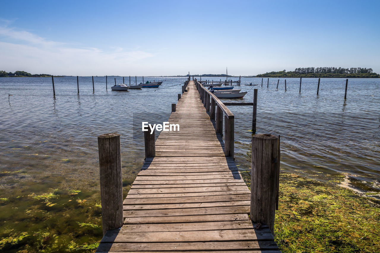 WOODEN PIER OVER LAKE