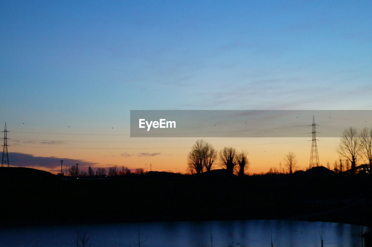 SCENIC VIEW OF SILHOUETTE LANDSCAPE AGAINST SKY AT SUNSET