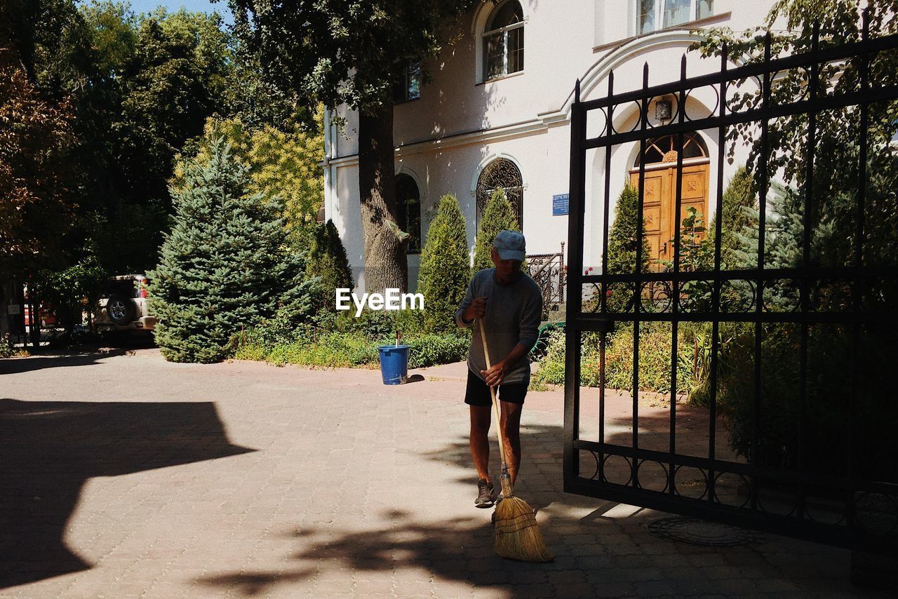 Man sweeping the yard