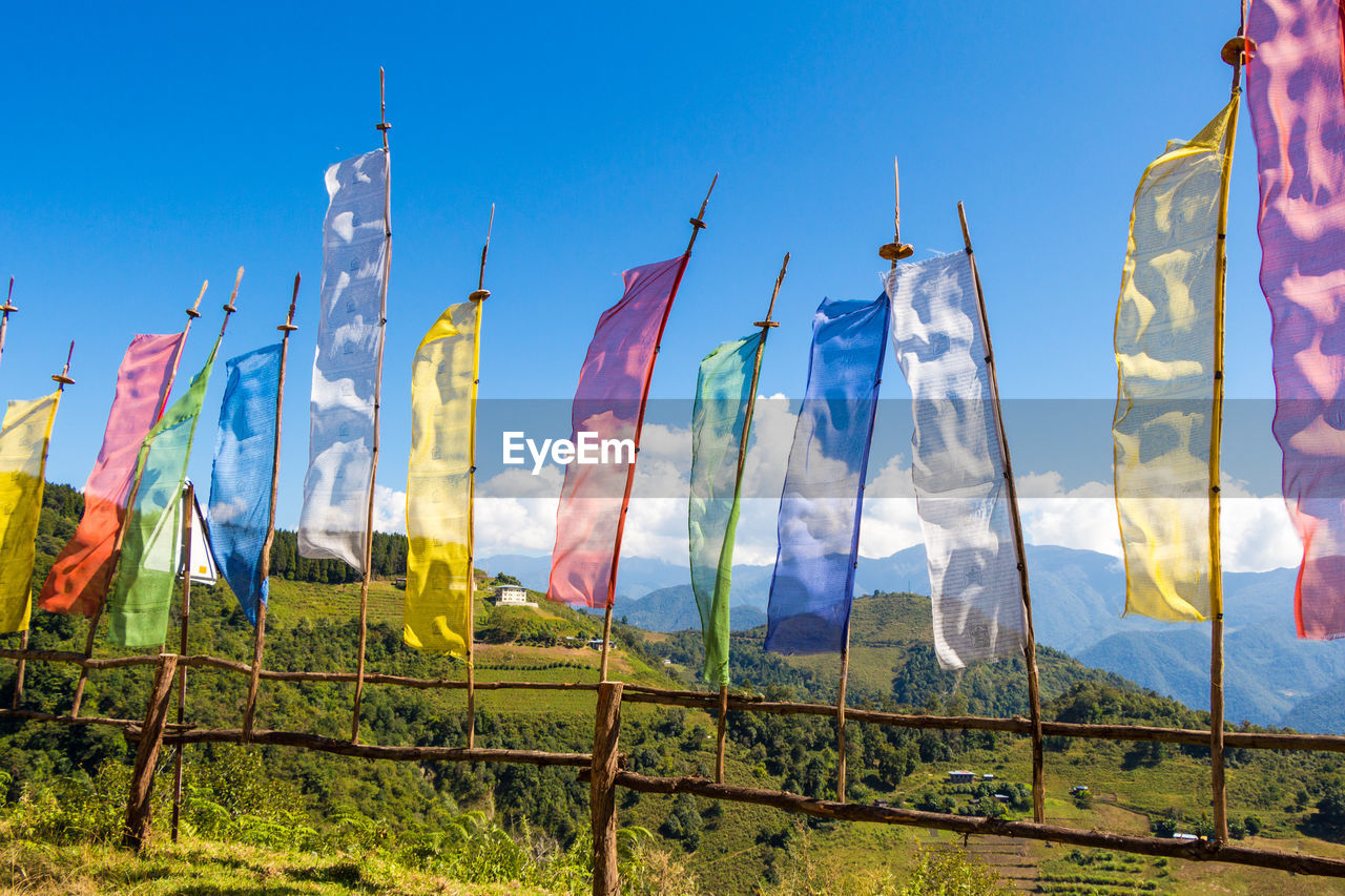 LOW ANGLE VIEW OF FLAGS AGAINST SKY