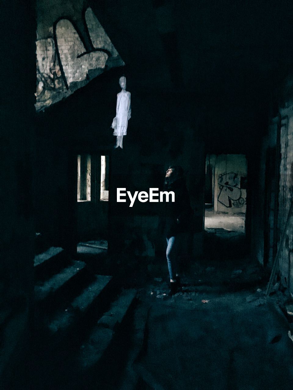 Young woman standing in abandoned building