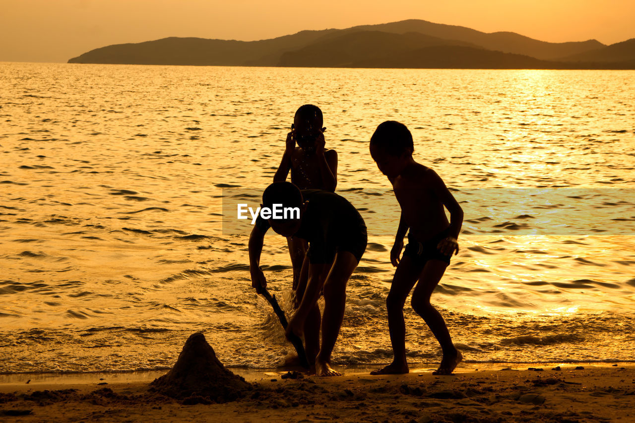 SILHOUETTE PEOPLE ON BEACH DURING SUNSET