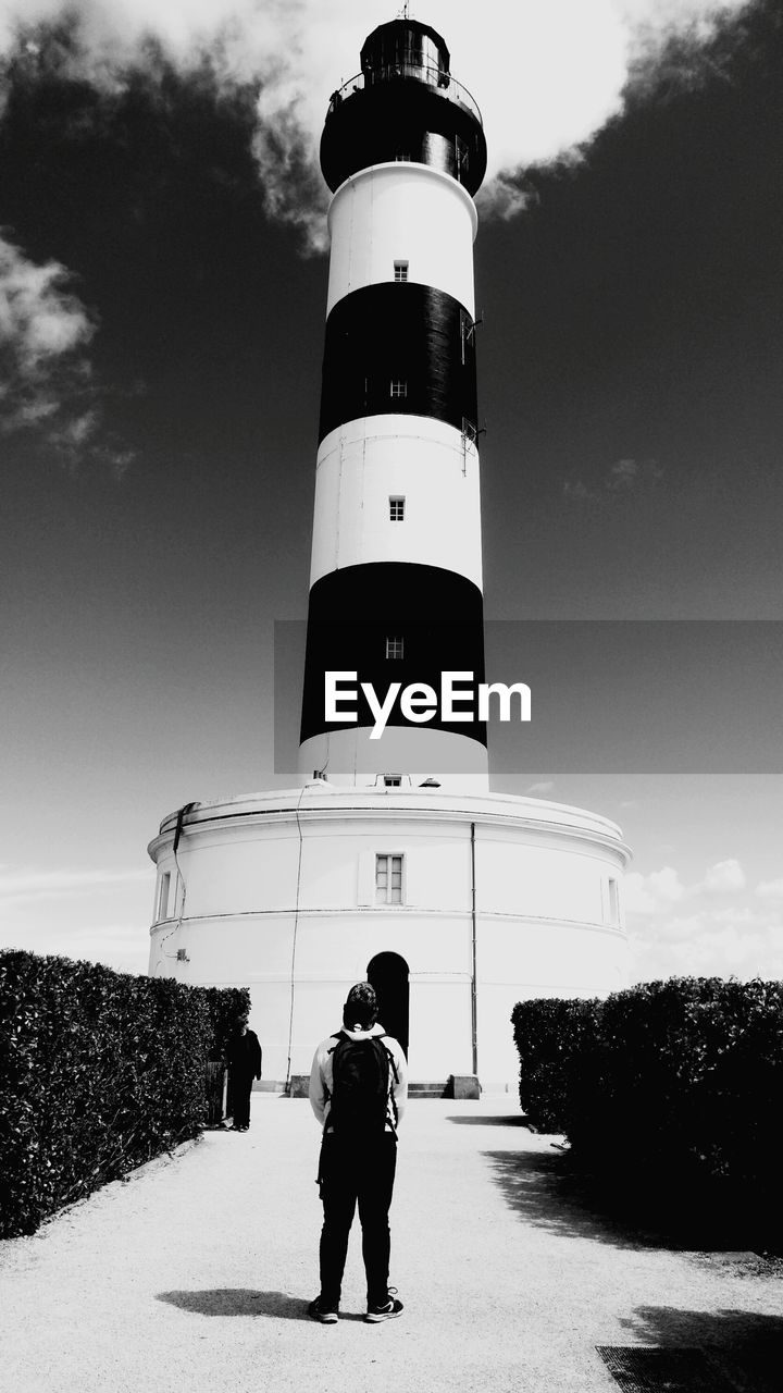 FULL LENGTH OF MAN STANDING ON LIGHTHOUSE