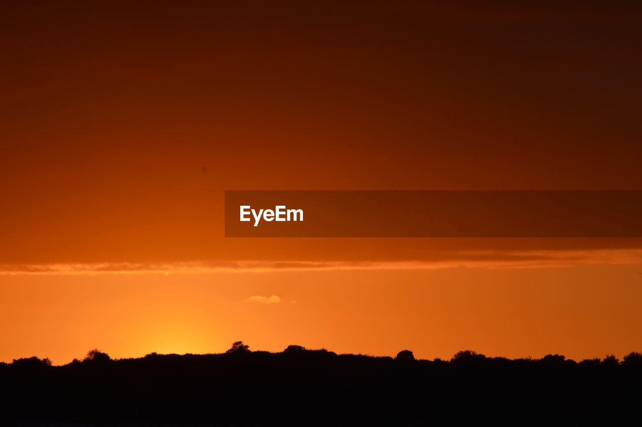 SCENIC VIEW OF SILHOUETTE LANDSCAPE AGAINST ORANGE SKY