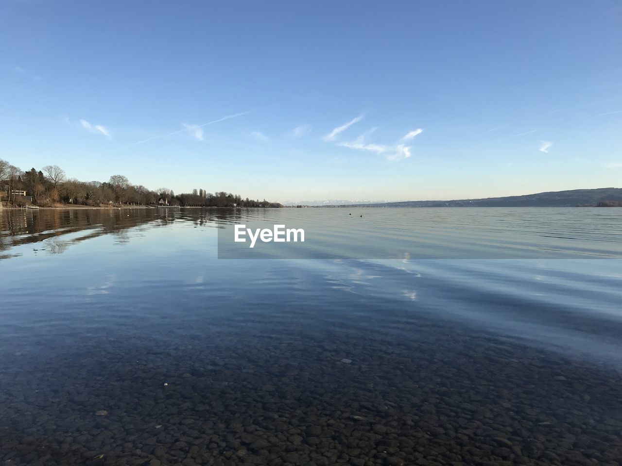 Scenic view of sea against blue sky