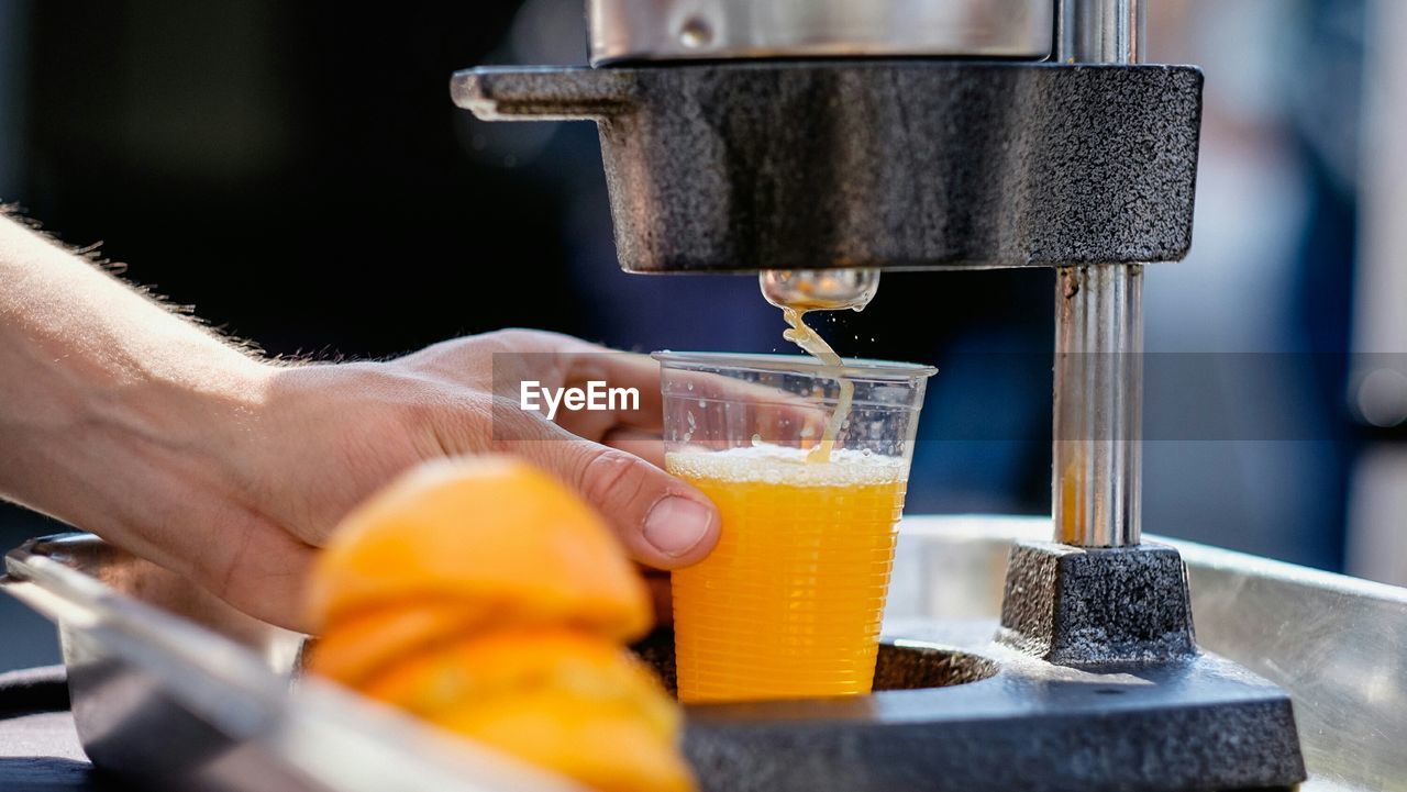 Close-up side view of hand holding drink