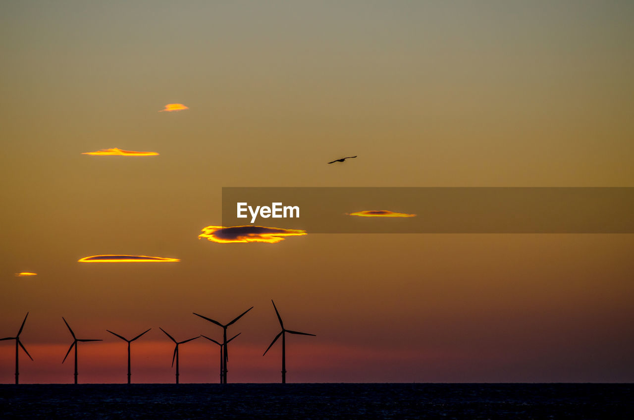 SCENIC VIEW OF SUNSET OVER SEA