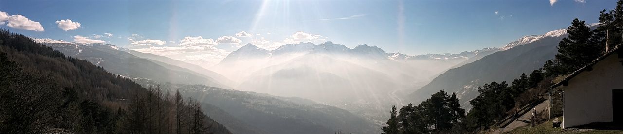 Panoramic view of mountains against blue sky