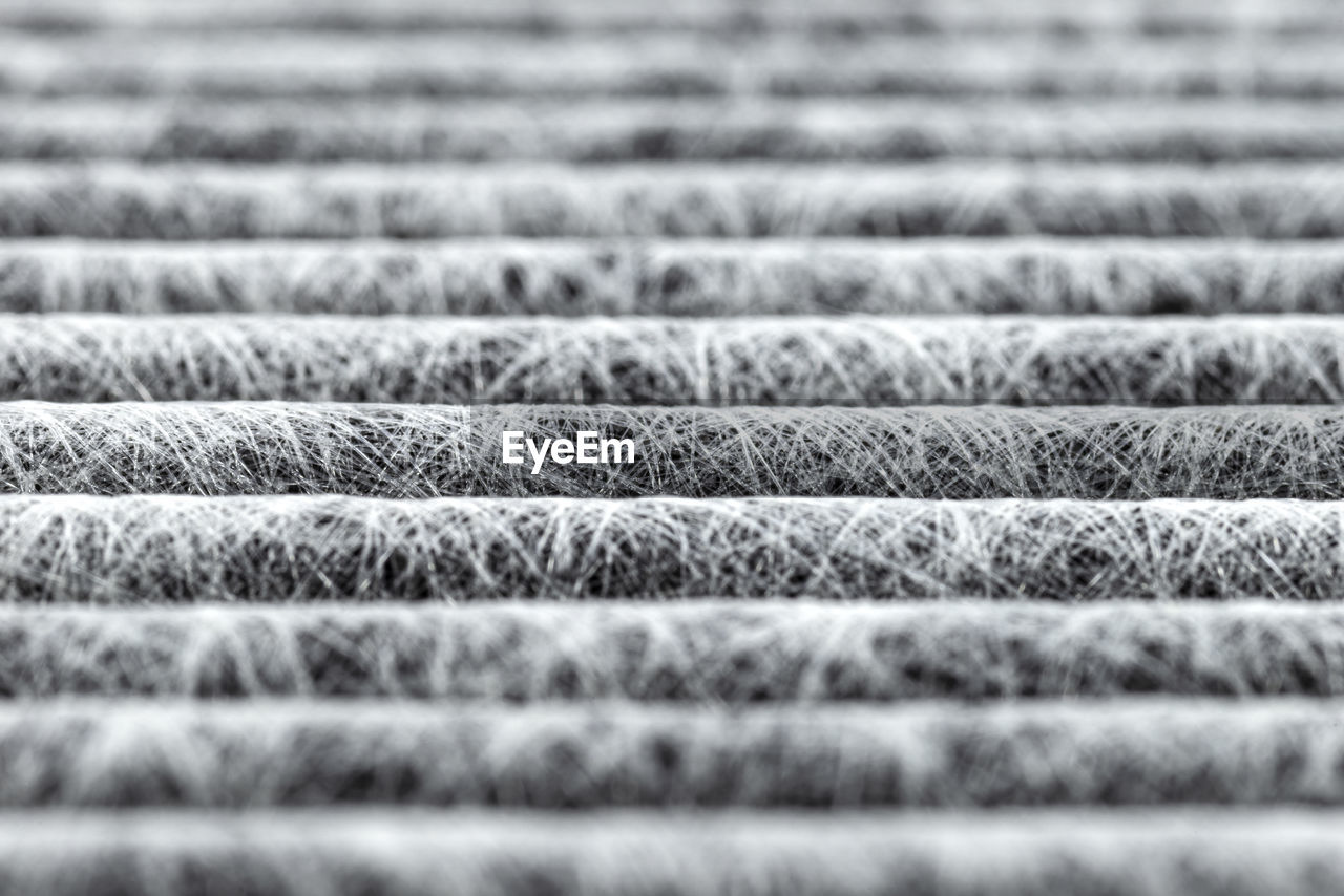 A macro shot of the surface rectangular, carbon cabin filter.fibers arranged in horizontal lines.