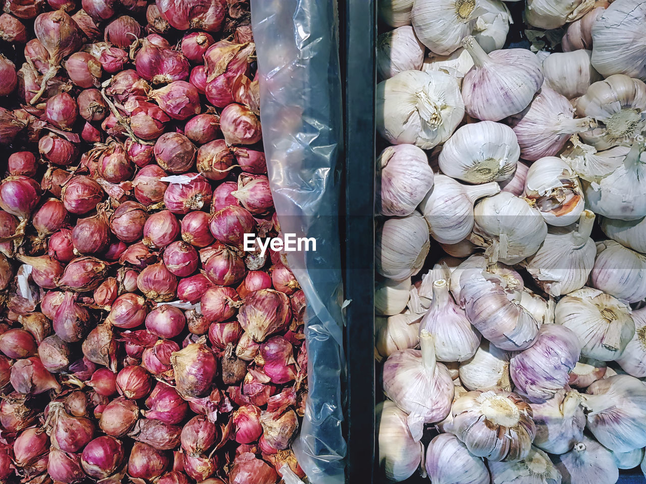Piles of fresh onion shallots and garlic