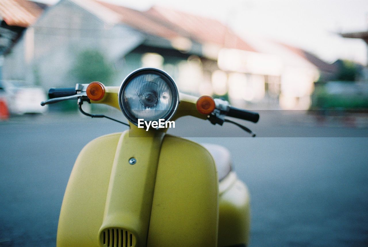 Close-up of old-fashioned scooter parked on road