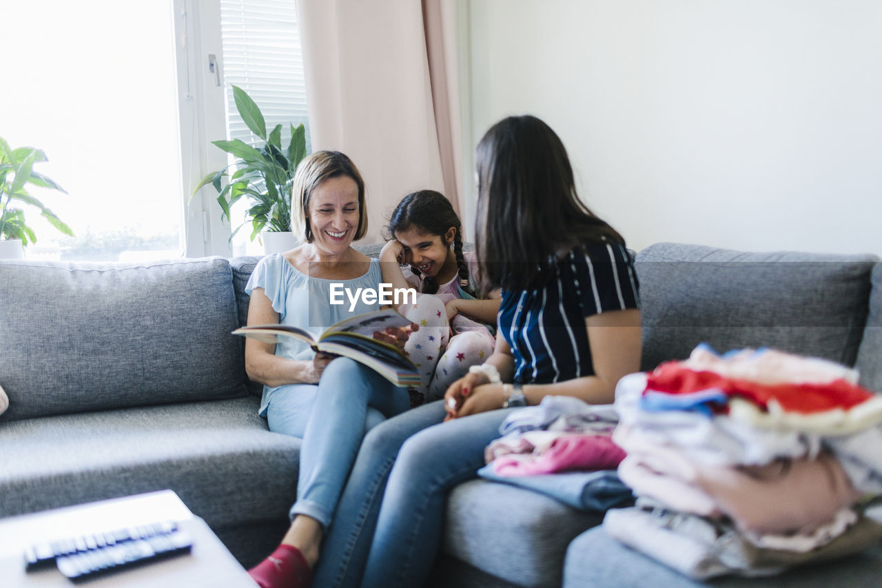 Mothers with daughter on sofa