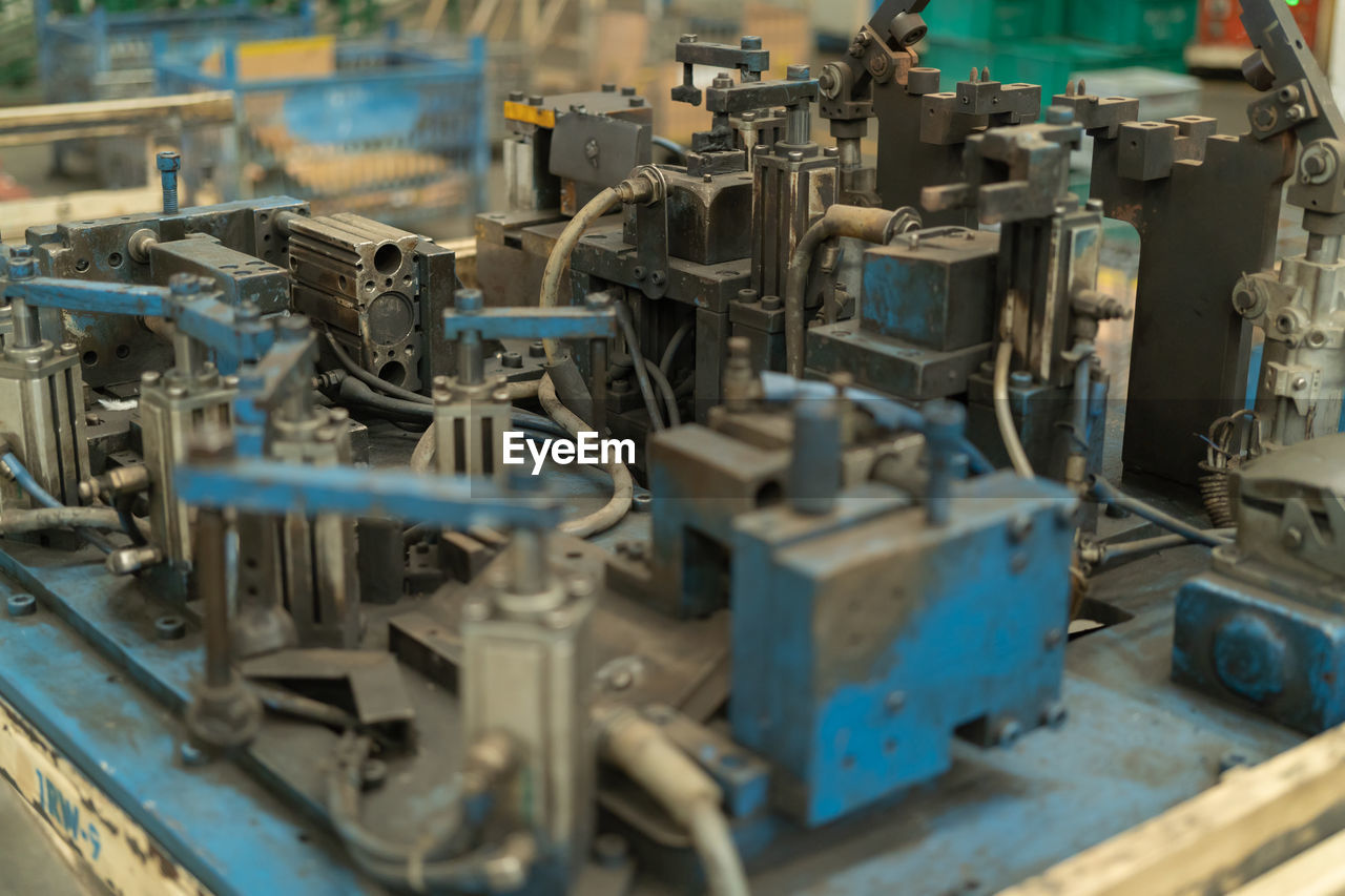 CLOSE-UP OF MACHINE PART IN INDUSTRY