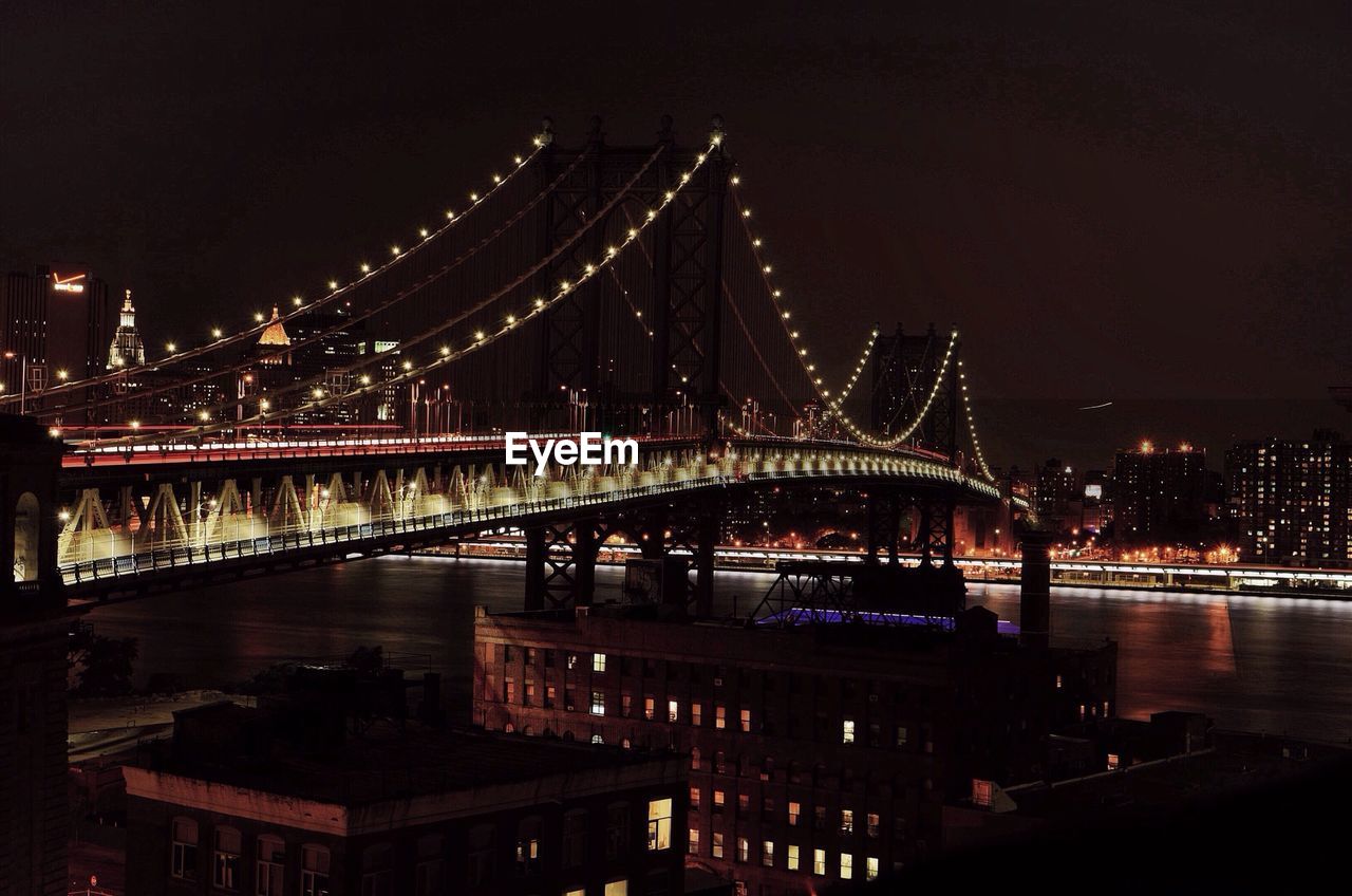 Illuminated bridge at night