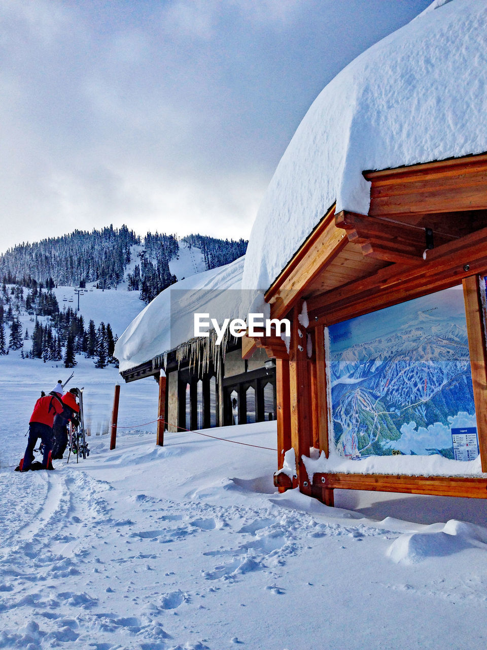 Snow covered ski chalet against sky