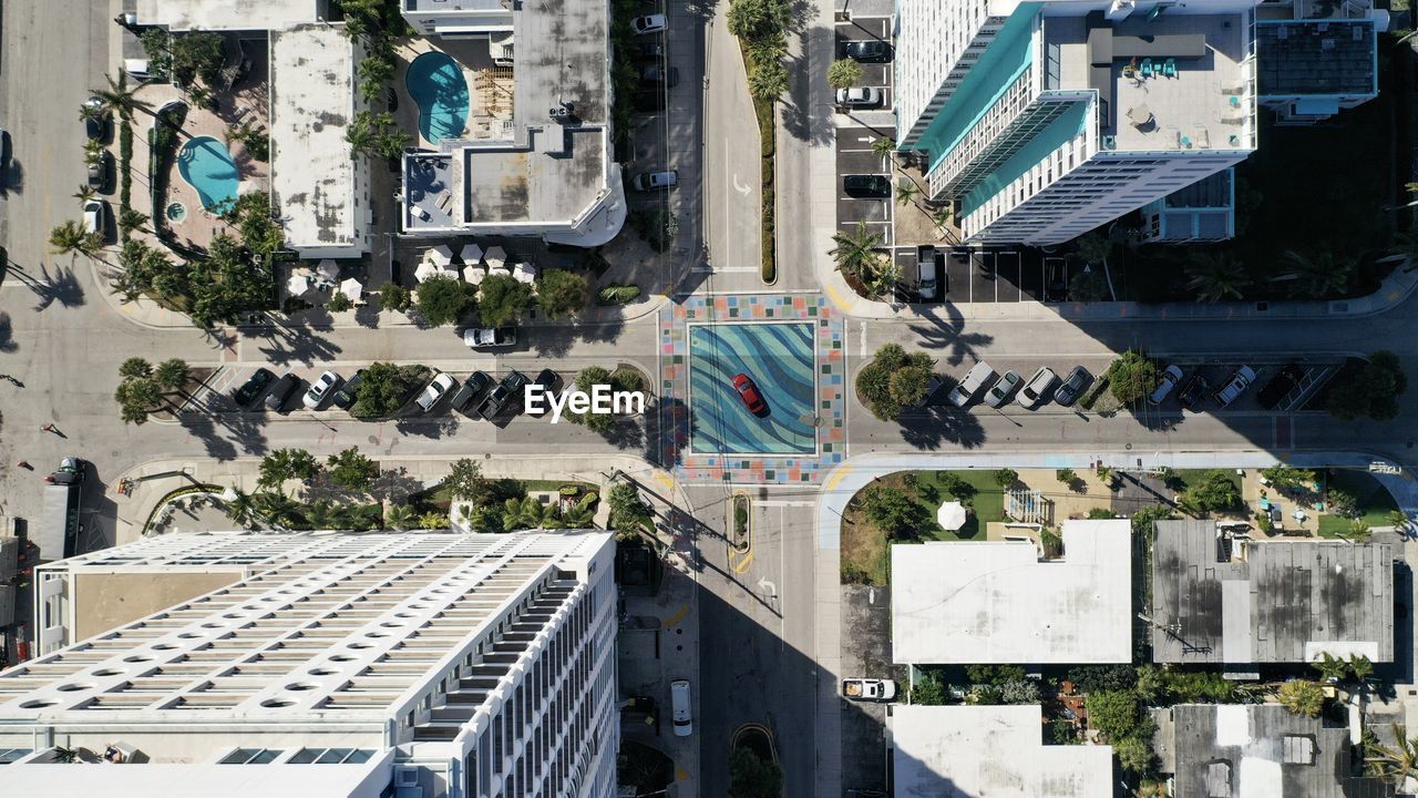 HIGH ANGLE VIEW OF ROAD AMIDST BUILDINGS