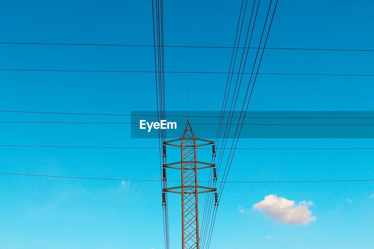 electricity, cable, technology, power supply, power line, electricity pylon, power generation, sky, blue, line, overhead power line, no people, nature, transmission tower, low angle view, tower, clear sky, electrical supply, outdoors, day, cloud, communication, built structure, architecture, public utility, outdoor structure, mast