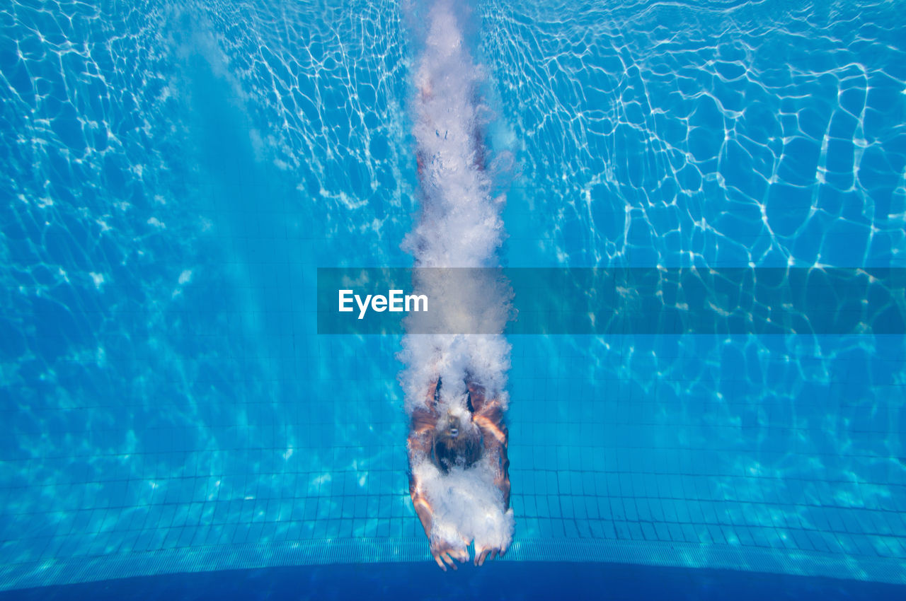 Mid adult woman swimming in pool