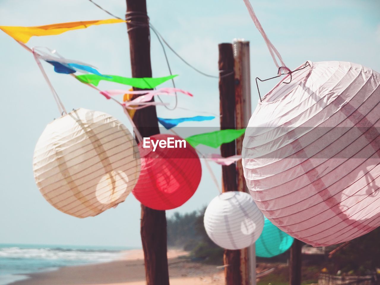 LOW ANGLE VIEW OF LANTERNS HANGING AGAINST SKY IN BACKGROUND