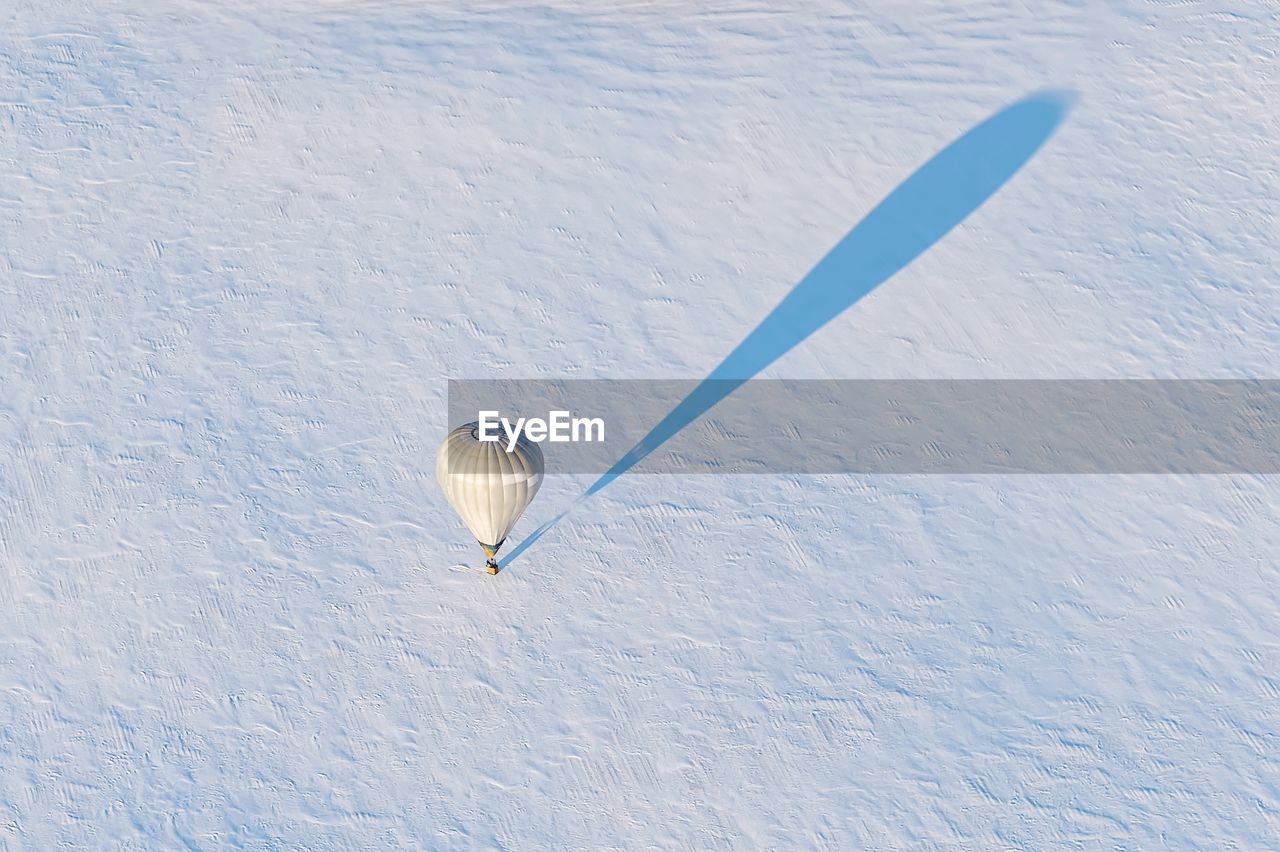 High angle view of hot air balloon on snow covered field