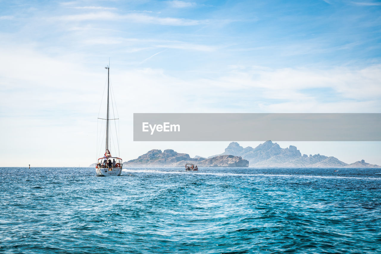 Sailboat sailing on sea against sky