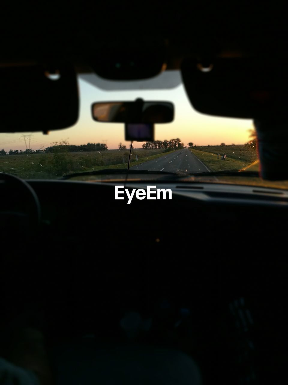 CLOSE-UP OF SILHOUETTE CAR ON WINDSHIELD
