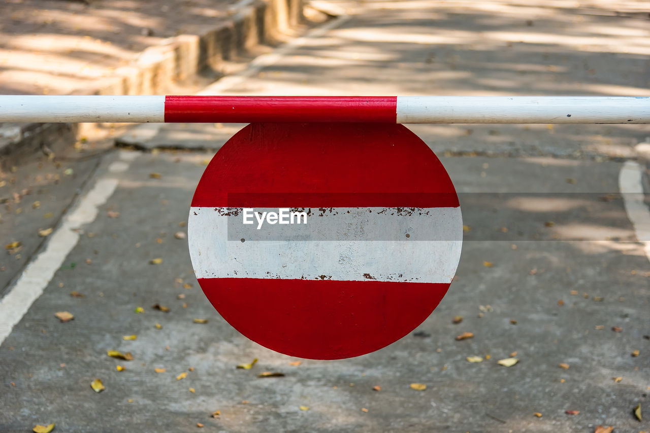 CLOSE-UP OF RED UMBRELLA ON STREET