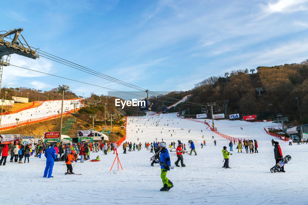 GROUP OF PEOPLE ON SNOW COVERED MOUNTAIN