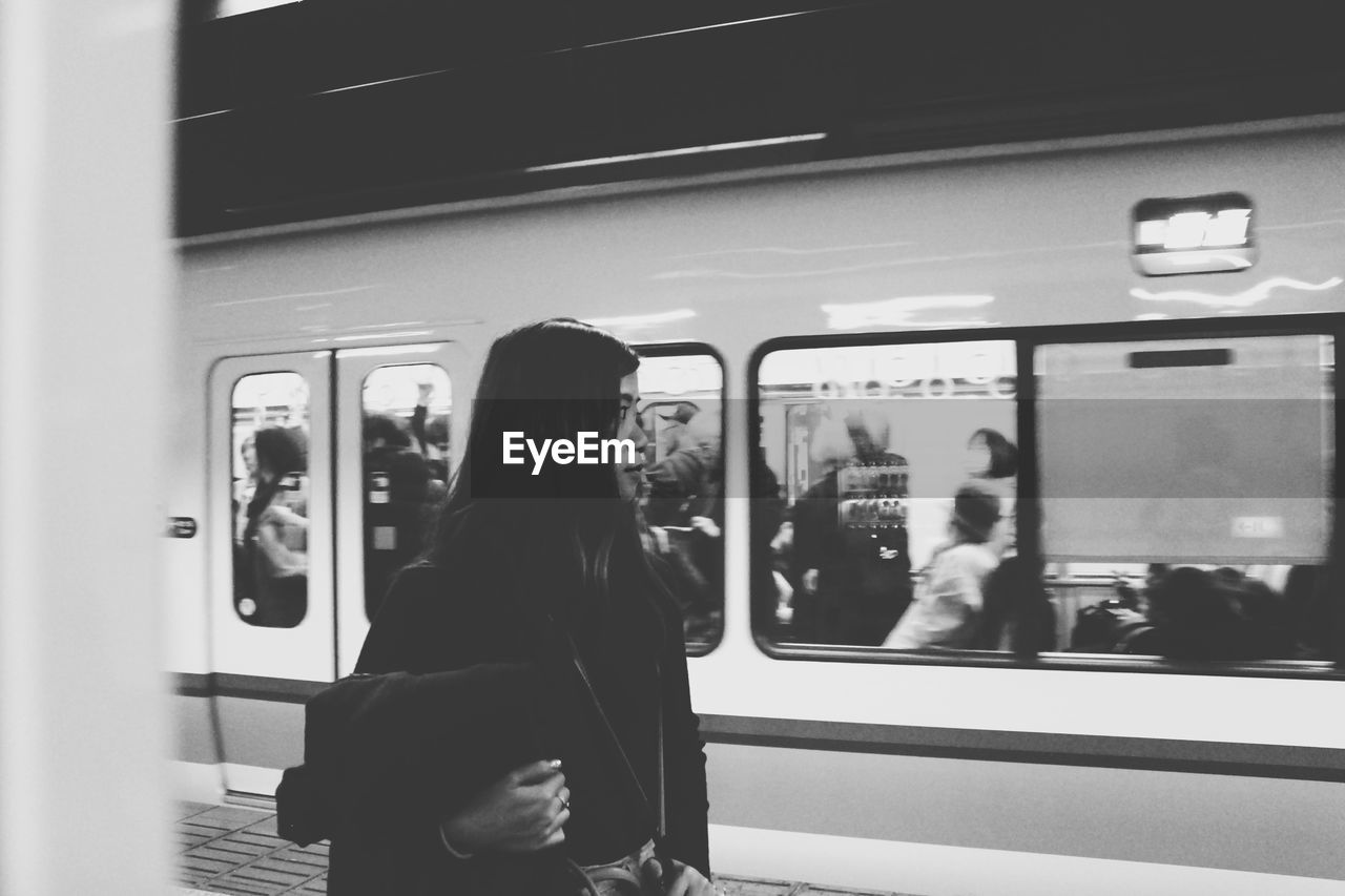 A woman waiting for the train, starting her journey to seek for a better future in life