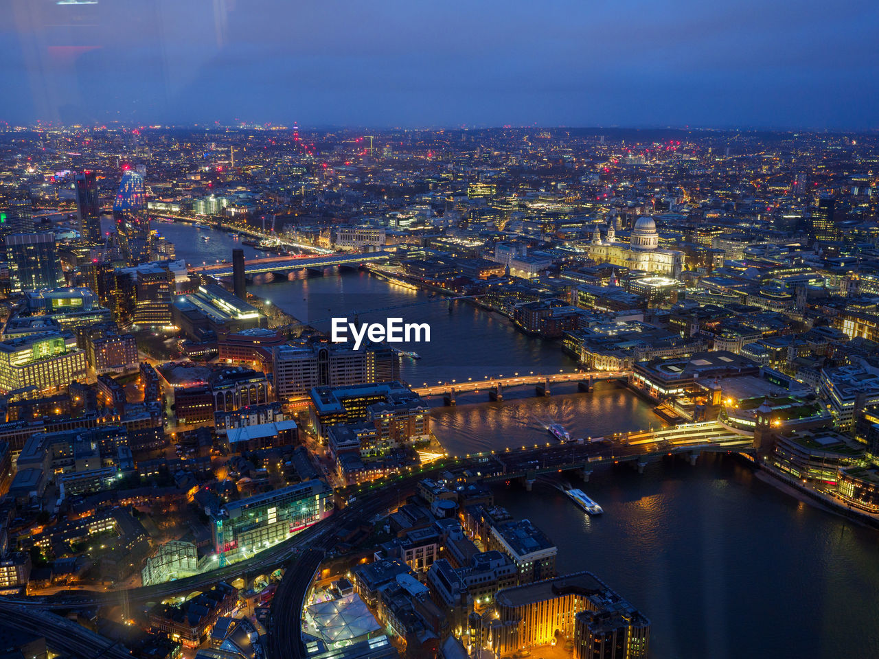 HIGH ANGLE VIEW OF ILLUMINATED BUILDINGS AT NIGHT