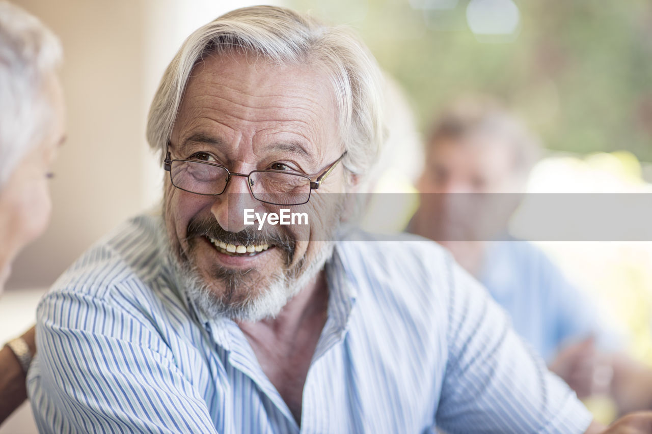 Portrait of smiling senior man wearing glasses