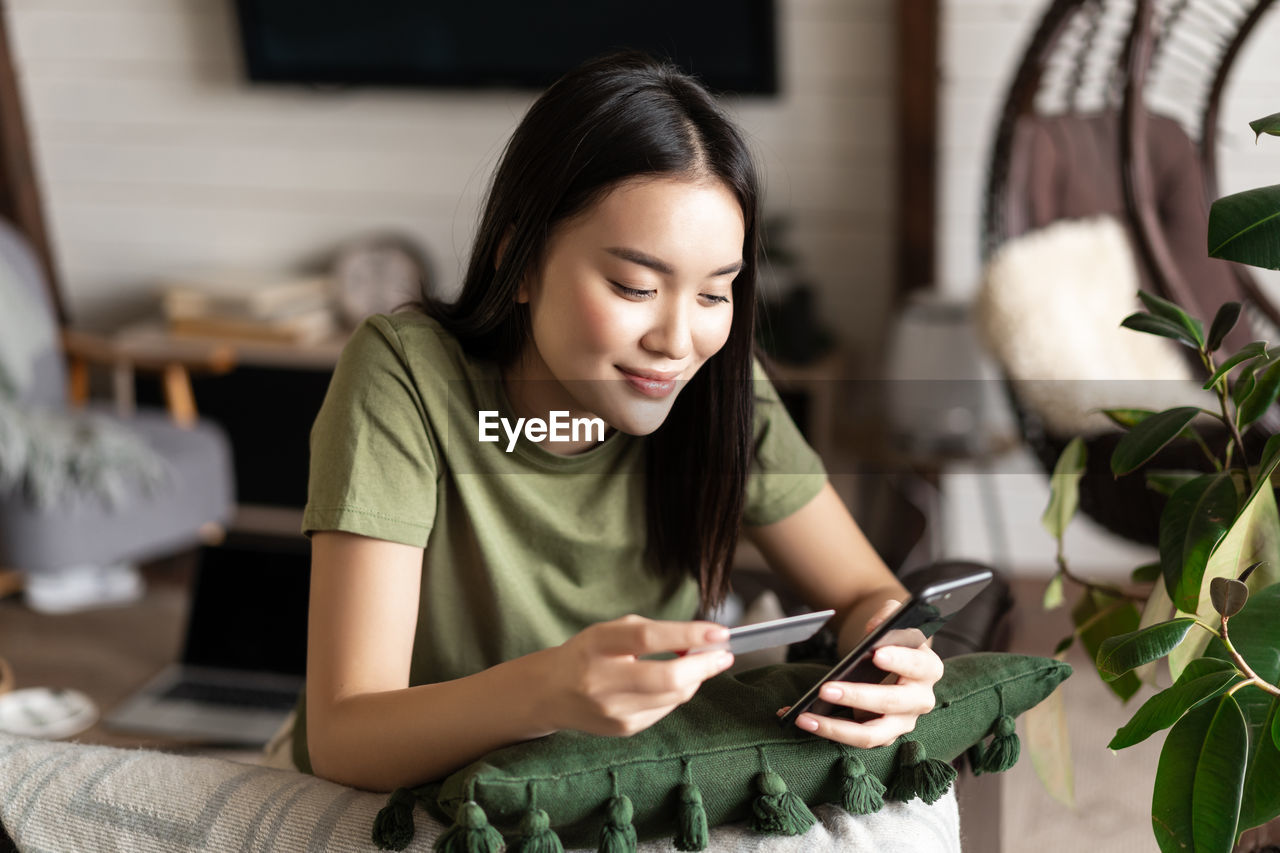 portrait of young woman using mobile phone