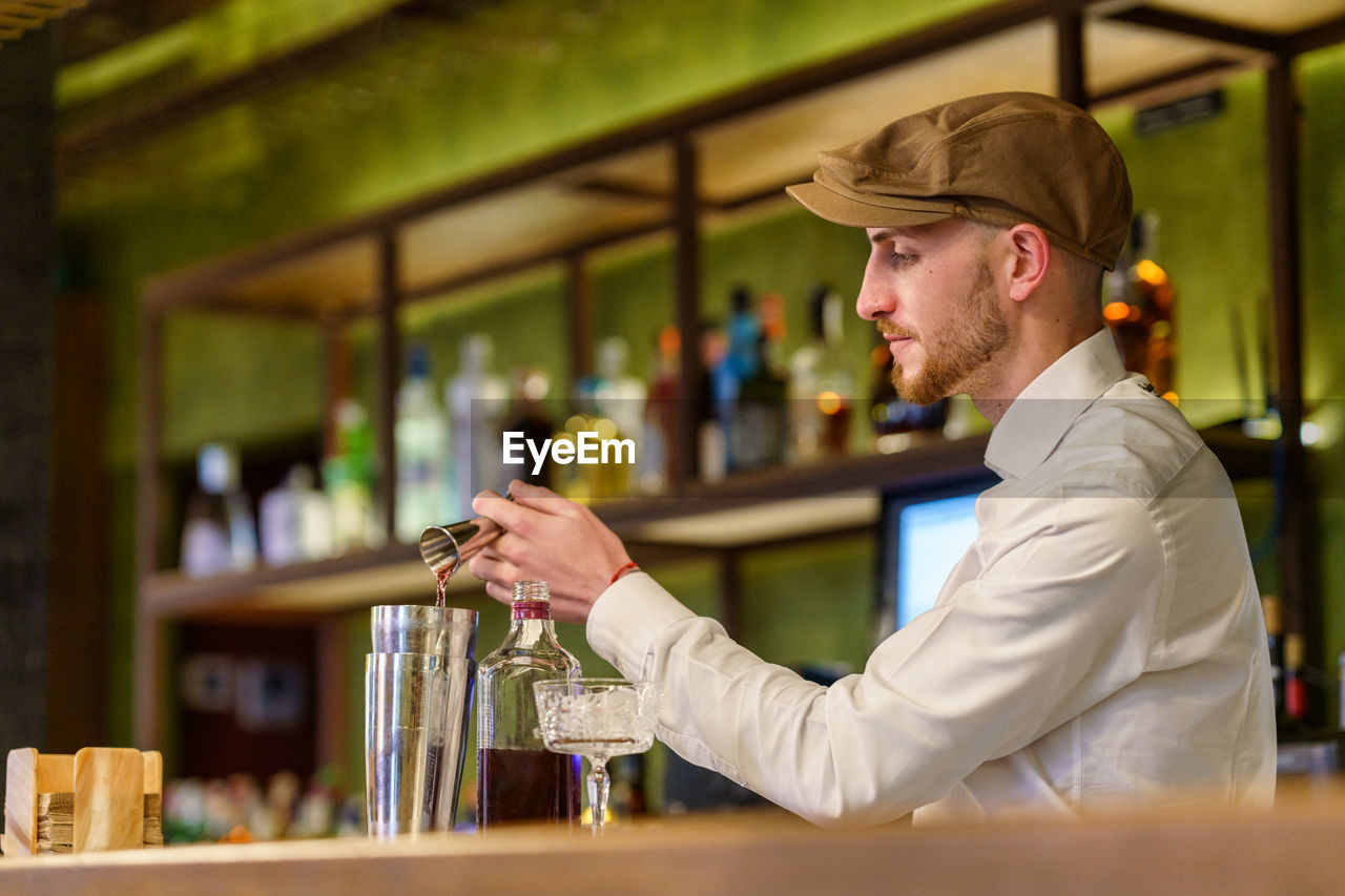 Bartender preparing drink at bar