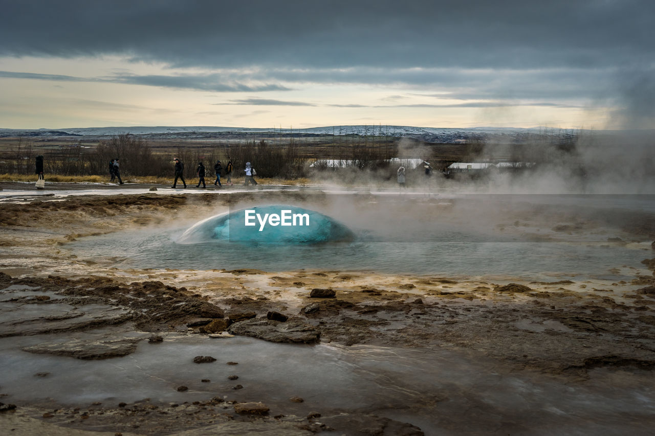 A bubble of water trapping the air as a geyser is about to erupt in iceland