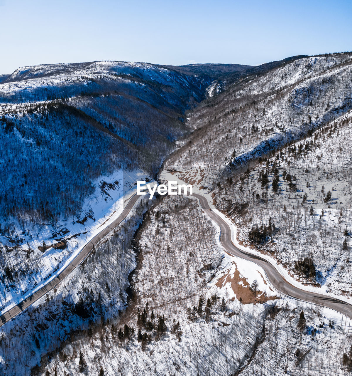 Aerial view of snowcapped mountains against sky