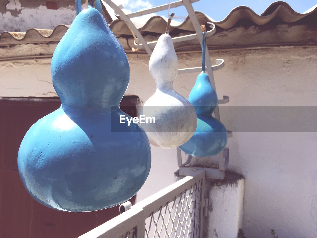 CLOSE-UP OF CLOTHES HANGING ON METAL RAILING