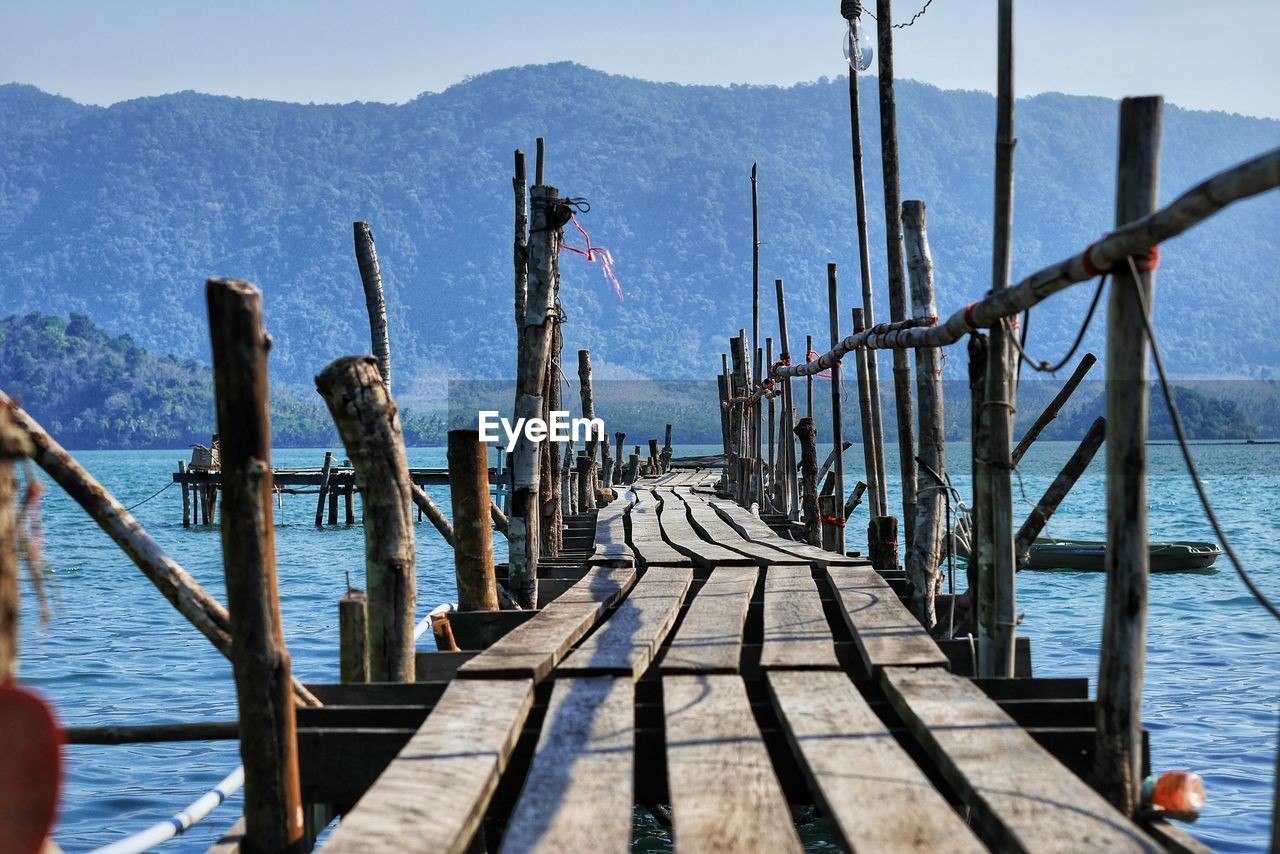 Wooden pier over sea against sky