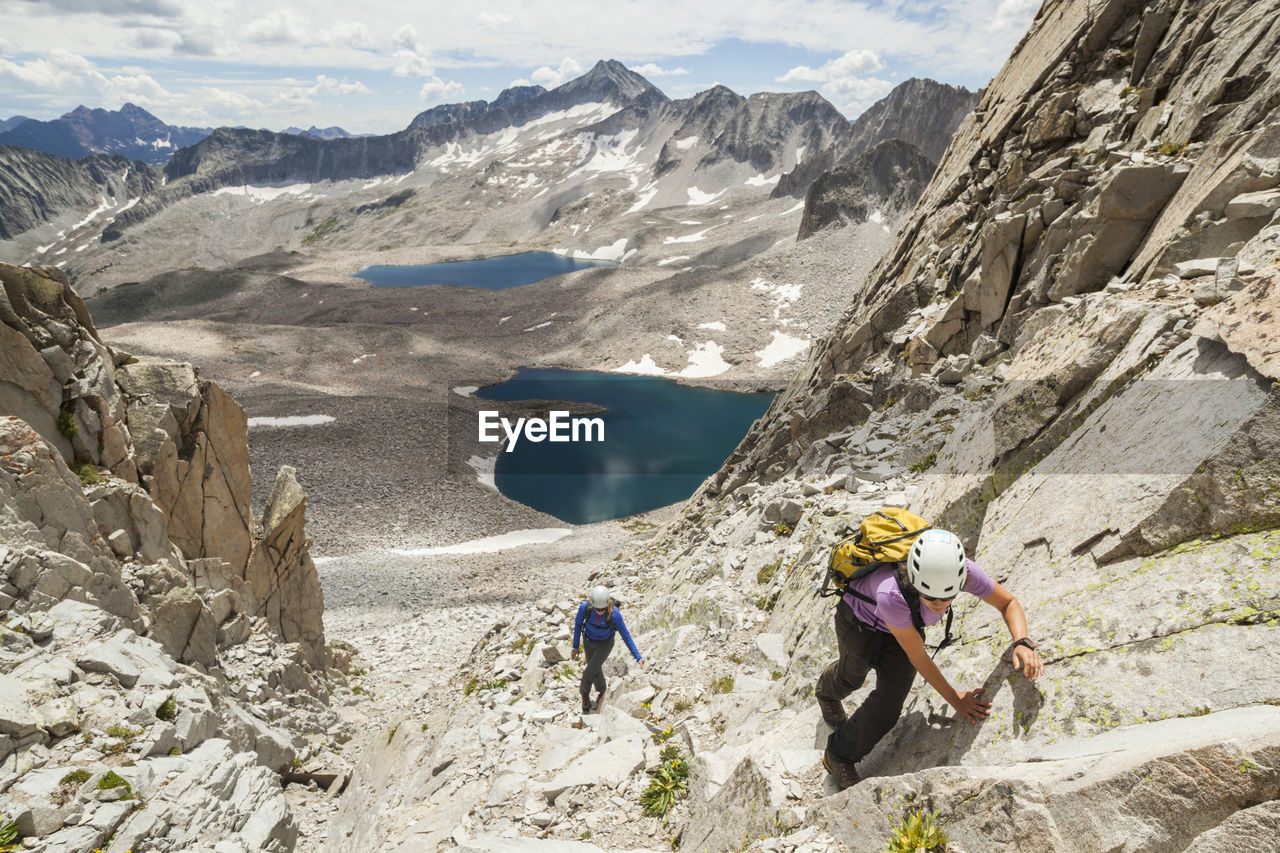 Women climb couloir above pierre lakes, elk mountains, colorado