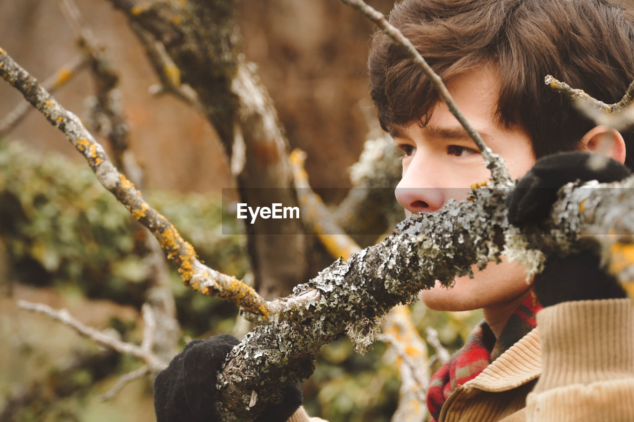 Close-up of thoughtful man by tree