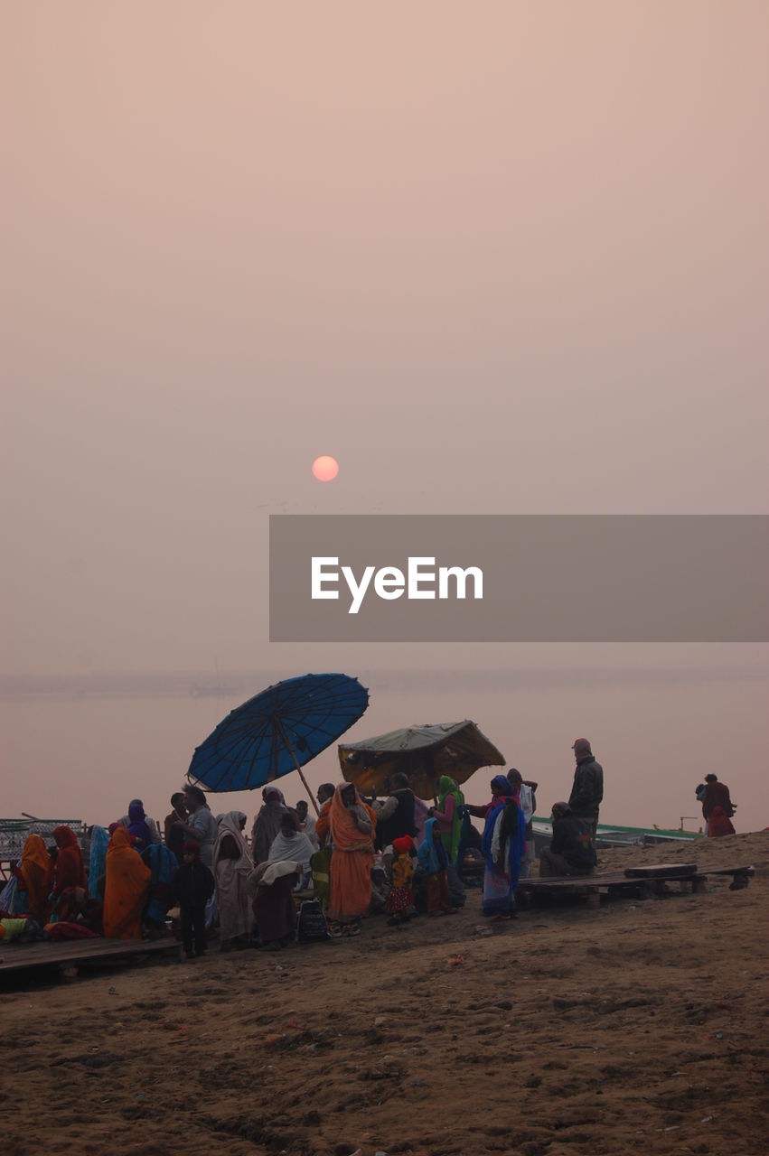 PEOPLE AT BEACH DURING SUNSET