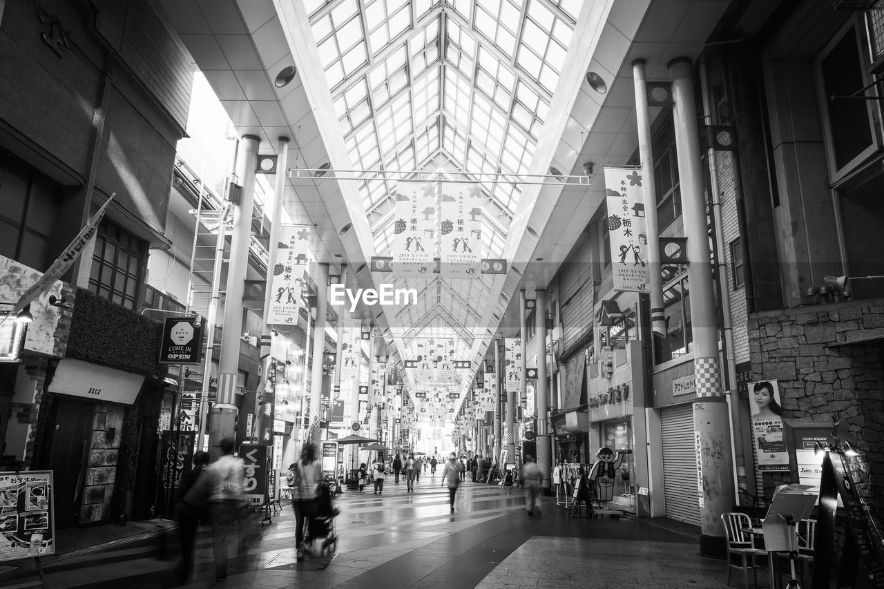 PEOPLE WALKING ON SHOPPING MALL