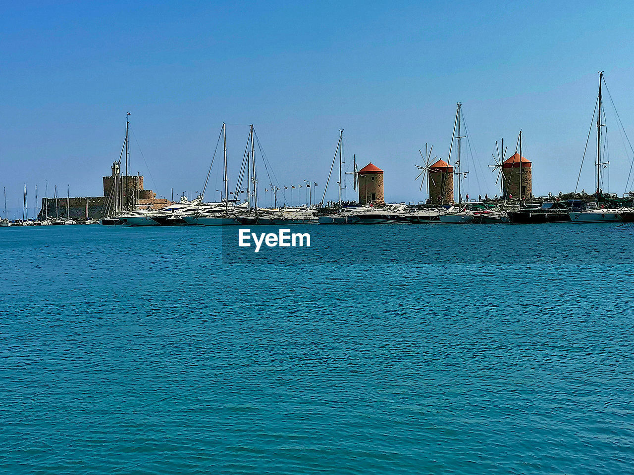 SAILBOATS IN SEA AGAINST BLUE SKY