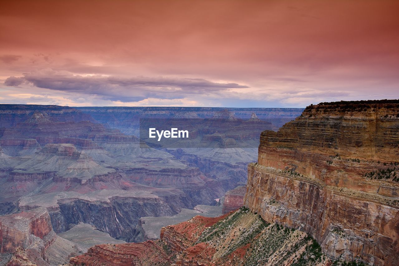 SCENIC VIEW OF ROCK FORMATION AGAINST CLOUDY SKY