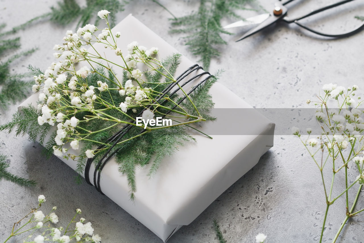 High angle view of flowers on gift at table