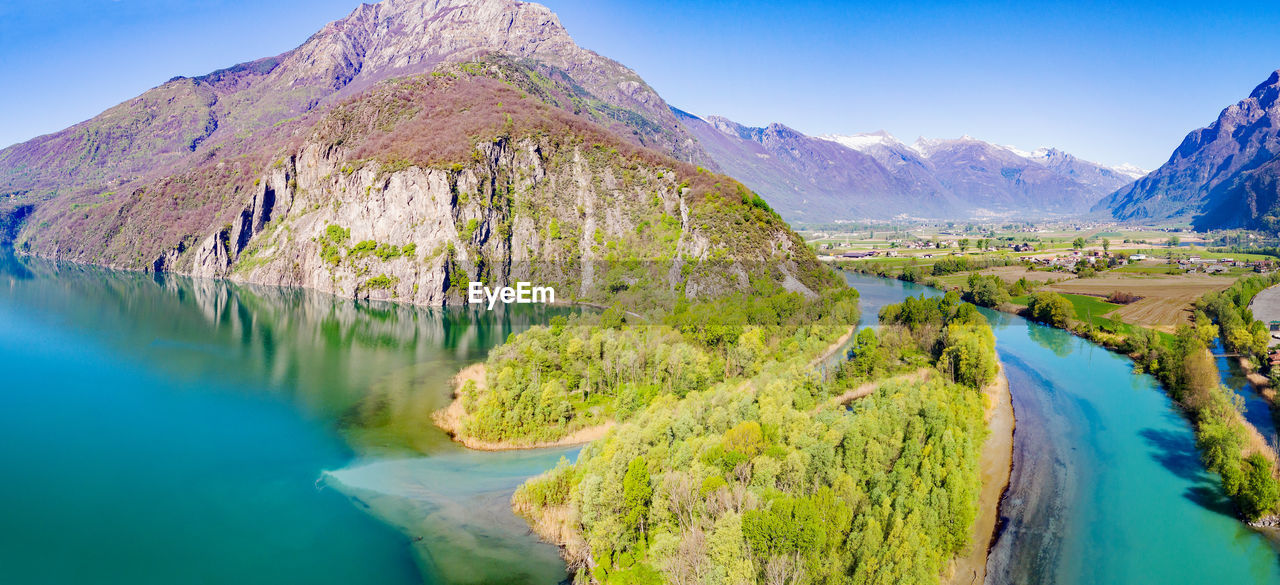 PANORAMIC VIEW OF LAKE WITH MOUNTAIN RANGE IN BACKGROUND