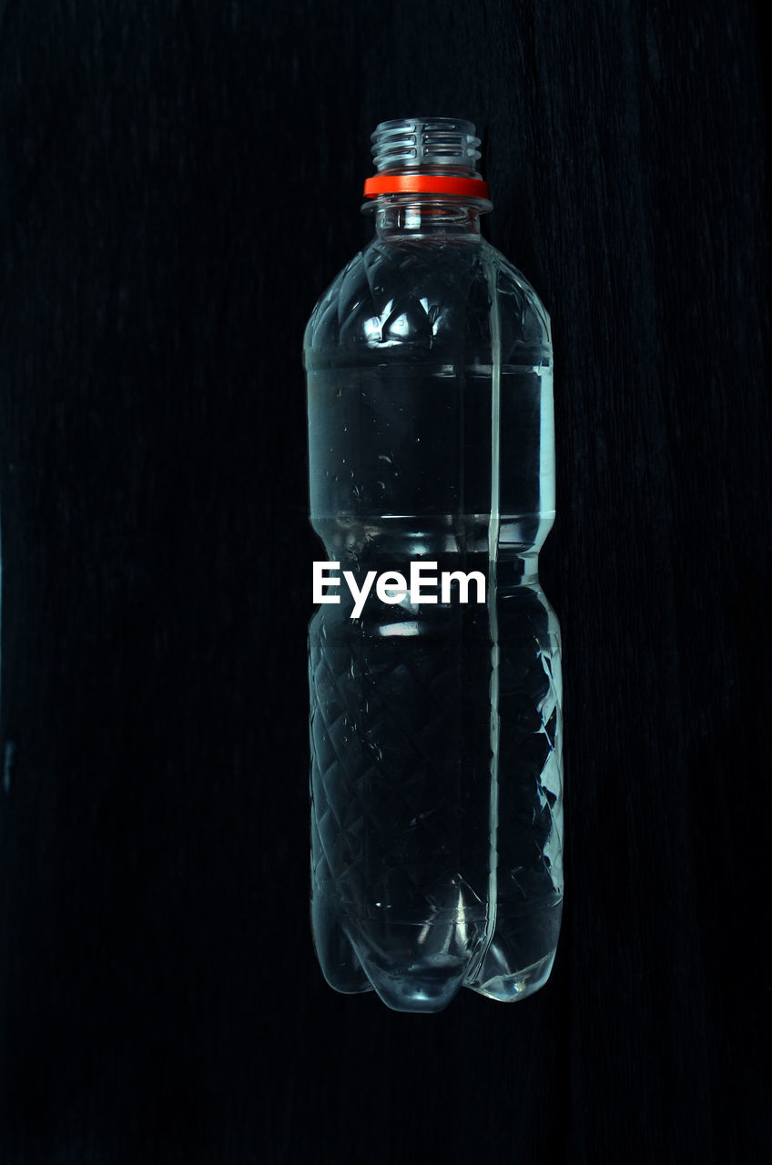 Close-up of bottle against black background