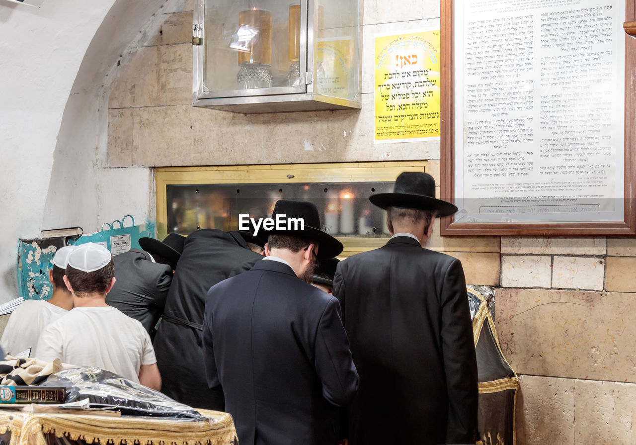 Rear view of jews praying in synagogue