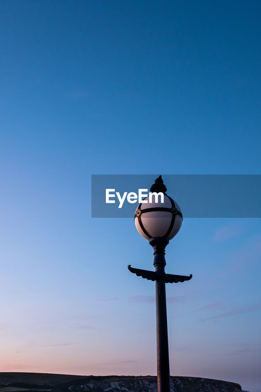 A old victorian lamp on the old pier, swanage at sunset.